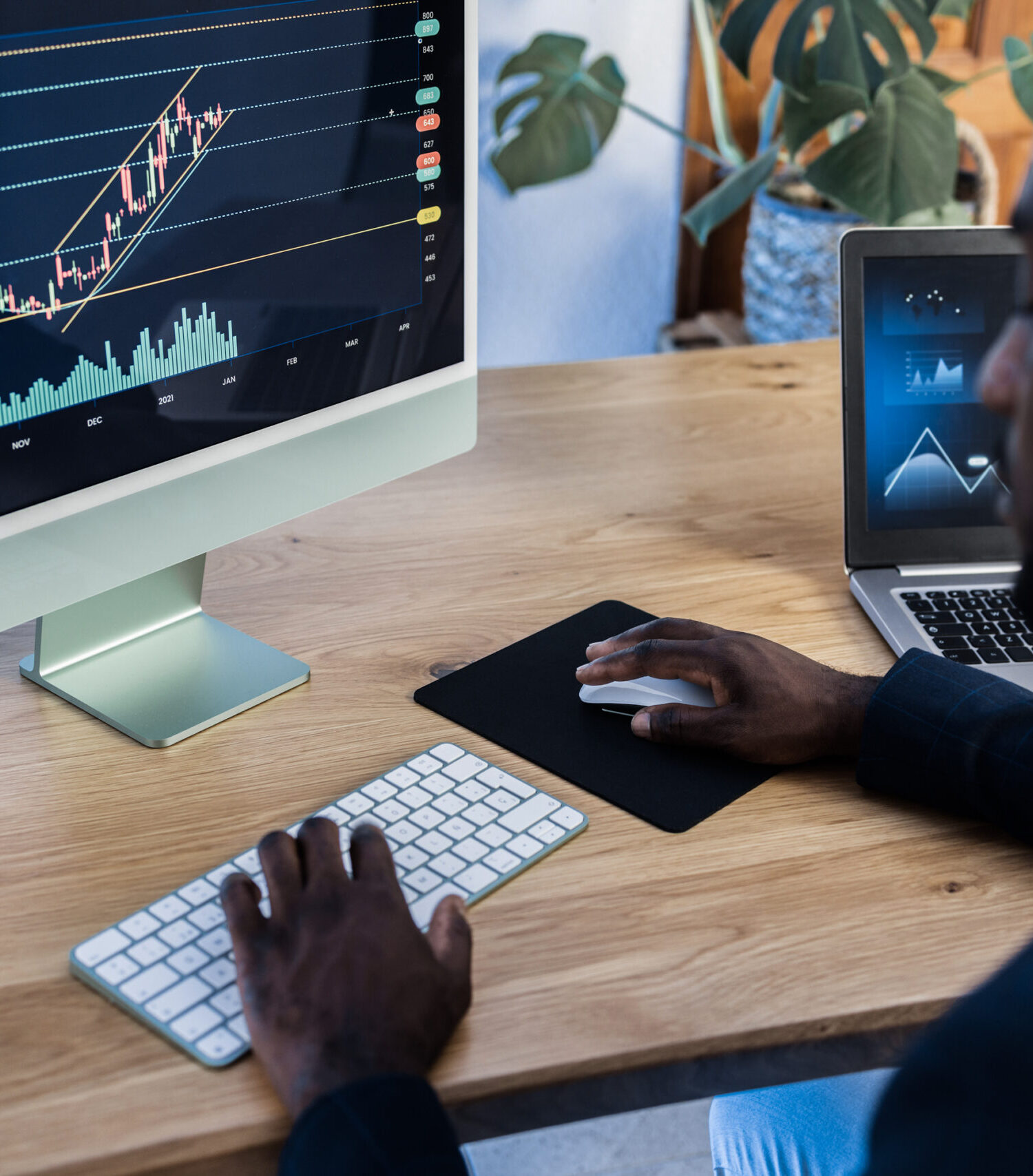 African trader studying stock market at home - Focus on computer screen