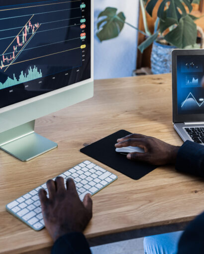 African trader studying stock market at home - Focus on computer screen