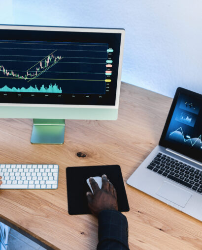 African trader studying stock market at home office - Focus on right hand