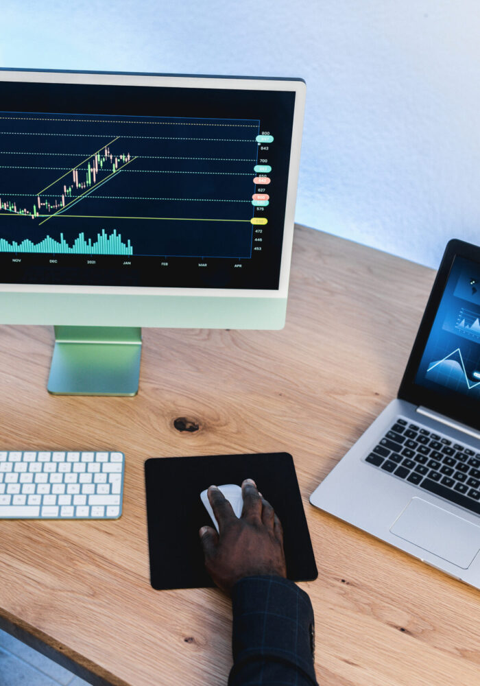 African trader studying stock market at home office - Focus on right hand