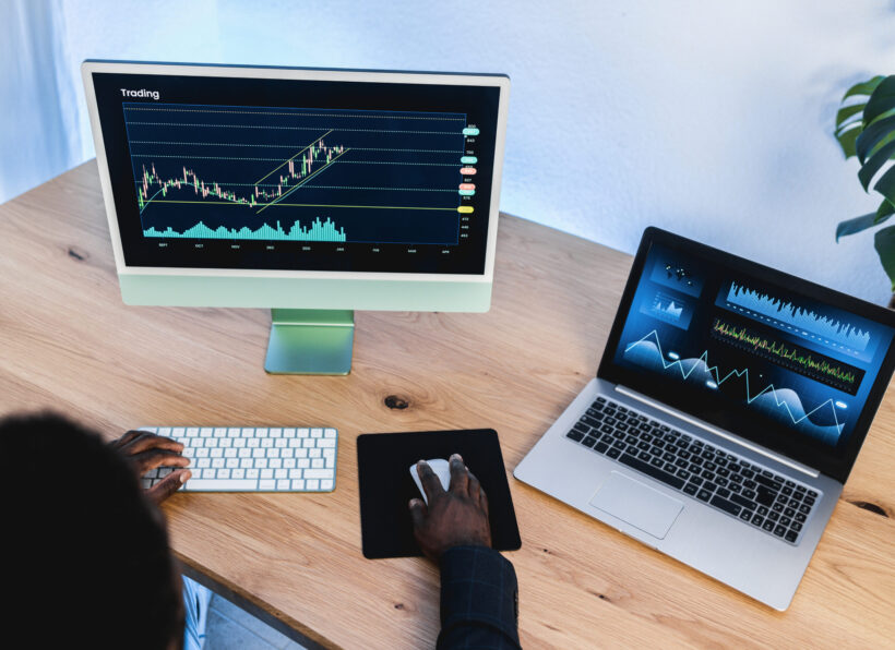 African trader studying stock market at home office - Focus on right hand